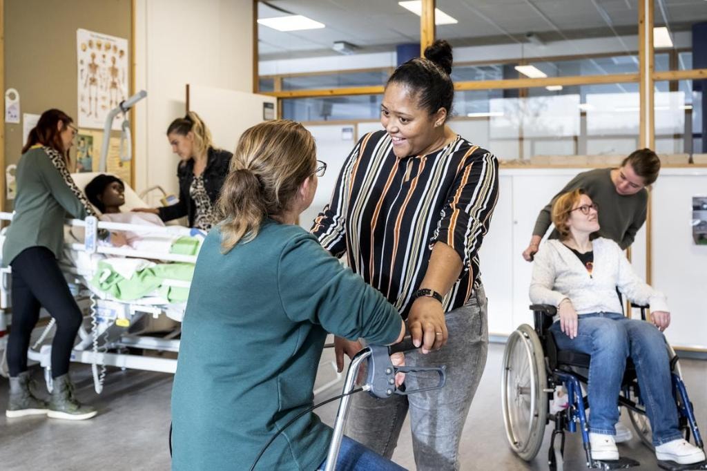 Healthcare professionals and participants in a hands-on caregiver workshop